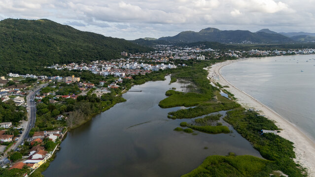 View of a Coastal Town With River and Beach on an Overcast Day