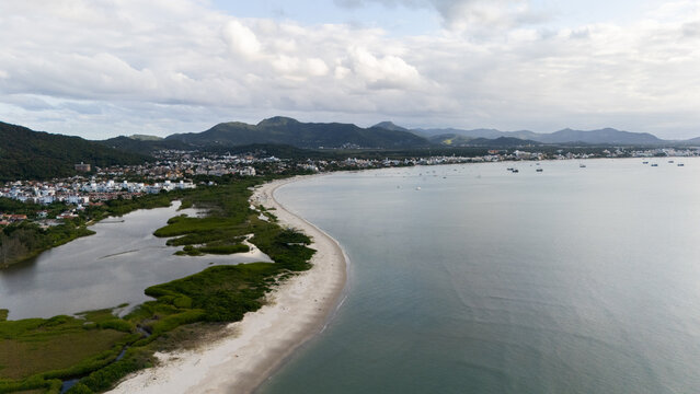 Coastline View With Water and Land at Sunset Near a Town In Floripa