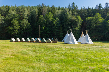 Summer camp with tipis and small tents in meadow © Richard Semik
