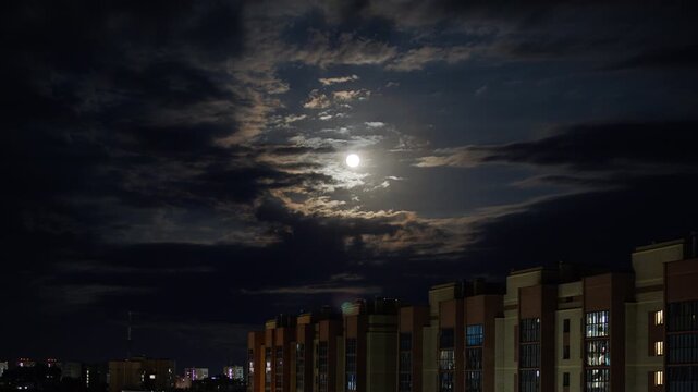 time lapse the moon through clouds over the city