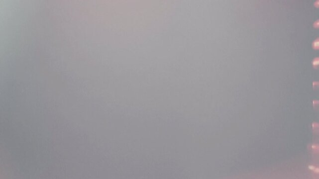 A close up view of a silver metallic surface reflecting light.