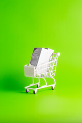 Buy two fine silver bars in white shopping cart on green background for vertical social media wealth investment.     © wibiwisnu