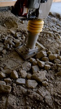 A vibroleg tamps stones. Selective focus.