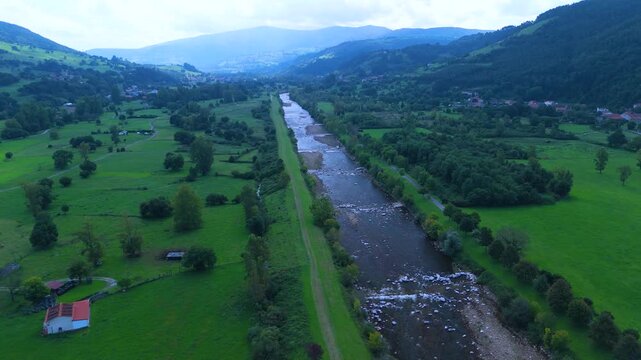 Aerial view from a drone of the Pas River in Corvera de Toranzo. Pas Valley in the Pasiegos Valleys region. Cantabria. Spain. Europe
