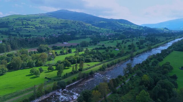 Aerial view from a drone of the Pas River in Corvera de Toranzo. Pas Valley in the Pasiegos Valleys region. Cantabria. Spain. Europe