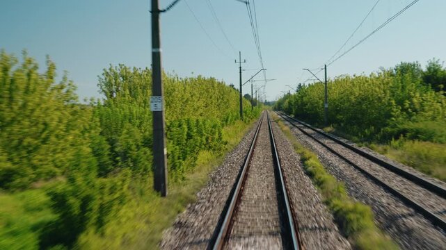 Electrified Railway Tracks Crossing Rural Green Landscape