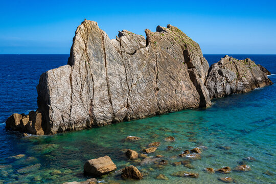 Aerial view of dramatic cliffs, sea stacks, and turquoise water along Costa Quebrada coastline, Cantabria, Northern Spain