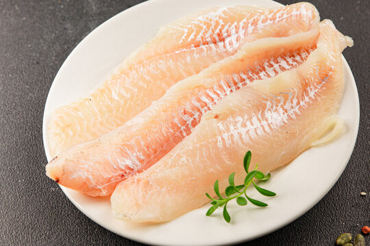 Sea bass fillet raw white fish, seafood healthy eating &nbsp;pescatarian diet healthful tasty dish, snack fresh gourmet rustic food background on the table top view copy space