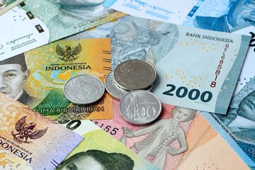 Indonesian rupiah money banknotes and coins on table. Indonesia cash bills of IDR currency © Viktor