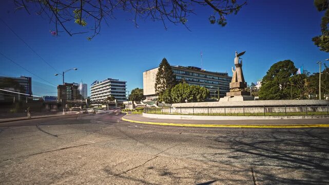 Morning timelapse in the Civic Center of Guatemala City. Vehicular traffic with long exposure and light trails around the roundabout.