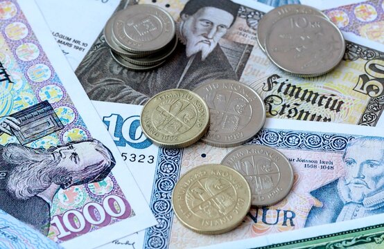 Icelandic krona money banknotes and coins on table. Iceland cash bills of ISK currency