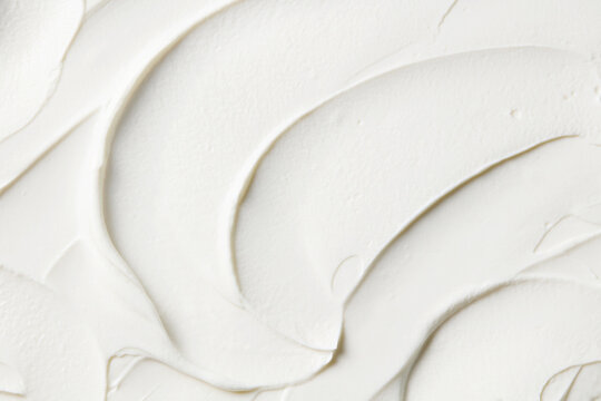 White texture waves background for cosmetic beauty branding, interior renovation or cake frosting. Close up. Top view.