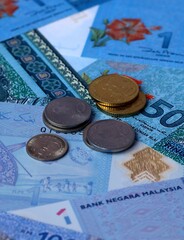 Malaysian ringgit money notes and coins on table. Malaysia cash bills of MYR currency close up © Marharyta