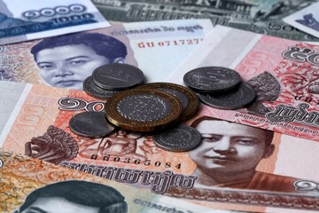 Cambodian riel money notes and coins on table. Cambodia cash bills of KHR currency close up © Marharyta