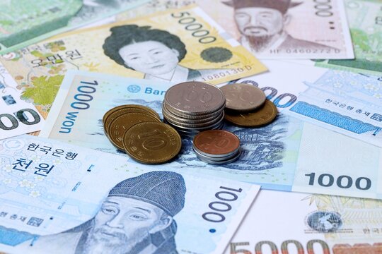 South Korean won money notes and coins on table. South Korea cash bills of KRW currency close up