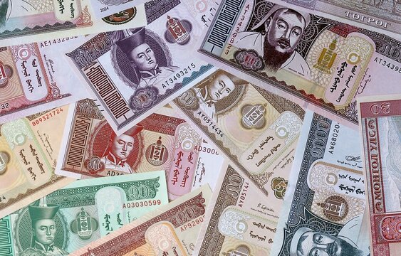Big amount of Mongolian tugrik money banknotes. Mongolia cash bills of MNT currency close up