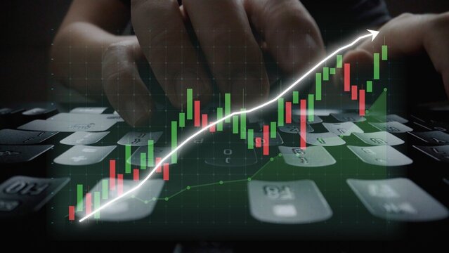 Dynamic scene of hands typing on a keyboard with an overlay of financial data showing upward trends in the stock market, reflecting growth and analytics in finance. Copula