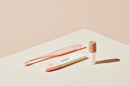 Rapid influenza test kit with a cotton swab and blank cassette on a smooth beige surface, airy and clean mockup for health banners