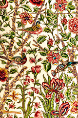 Persian and Central Asia carpet background. Ornate floral and bird illustration with colorful botanical motifs in a framed decorative textile panel, vertical Persian style artwork © Irina Mikhailichenko