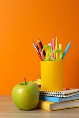 Yellow holder with stationery on table, closeup, vetical view © Sunlight
