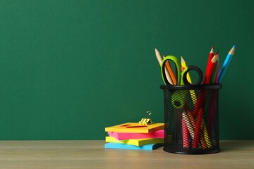 Black holder with stationery on table, copy space © Sunlight