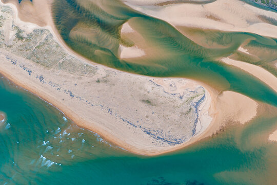 Aerial view of dramatic cliffs, sea stacks, and turquoise water along Costa Quebrada, Cantabria, Spain
