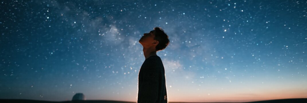 Lone person silhouette under a vivid starry sky with milky way for nightscape wallpaper and inspirational poster background