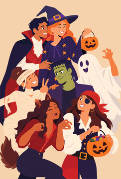 Group of happy young friends in spooky costumes celebrating Halloween party
