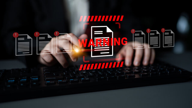 A digital representation of cybersecurity risks, featuring hands on a keyboard alongside a warning alert. This image emphasizes the importance of document protection and data safety. Gantry