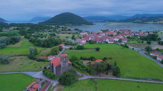 Church of Santa Cruz and town of Escalante seen from a drone in the Parque Natural de las Marismas de Santo&ntilde;a, Victoria y Joyel Natural Park. Cantabrian Sea. Escalante, Cantabria, Spain, Europe