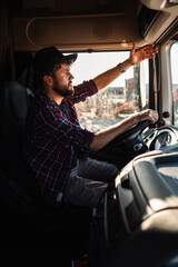 Truck driver navigating in cabin of large vehicle during daylight © milanmarkovic78
