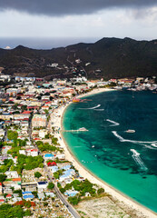 Fototapeta premium Aerial view of Great Bay Beach with turquoise water and the urban skyline of Philipsburg in Sint Maarten, Caribbean Netherlands