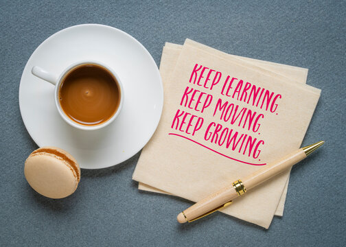Keep learning, moving and growing.Inspirational quote on a napkin with coffee. Lifelong learning, personal development, active aging, continuous improvement, and maintaining curiosity.