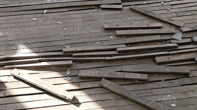 Wooden planks piled on a roof, perhaps for repair or new construction
