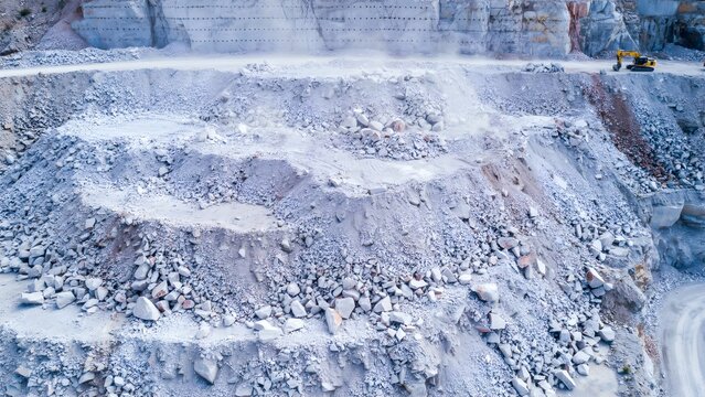 Open-pit quarry excavation with terraced levels and rocky debris