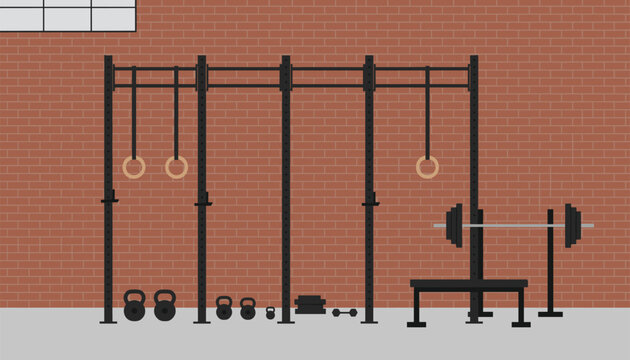 Industrial crossfit gym interior featuring pull-up rig structure, gymnastics rings, kettlebells and barbell.