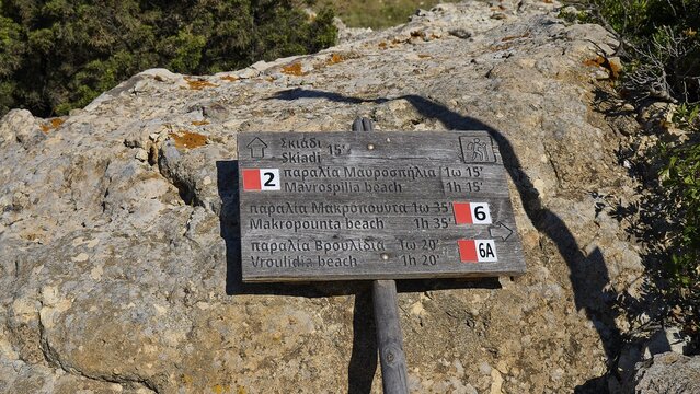 Wooden trail sign on rocks showing various hiking destinations, mushroom rocks, mushroom rock, bizarre rock, rock formation, Skiadi, Kimolos, Cyclades, Greek Islands, Greece