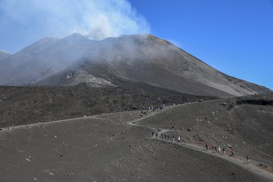 Hiker in the crater landscape of the volcano Etna, summit, Province of Catania, Sicily, Italy