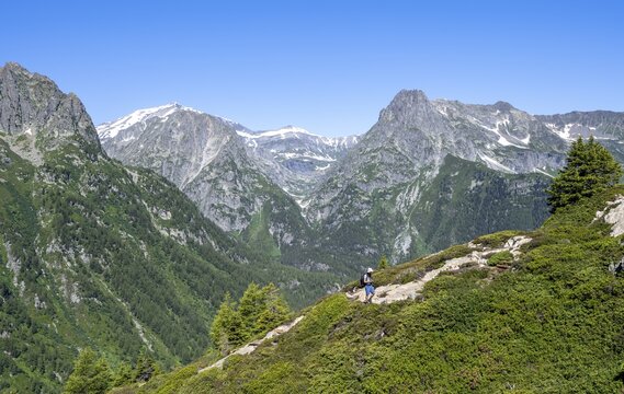 Mountaineer on hiking trail to Aiguillette des Posettes, mountain panorama with summit Mont Bues and Pointe de la Terasse, Chablais Alps, Chamonix, Haute-Savoie, France