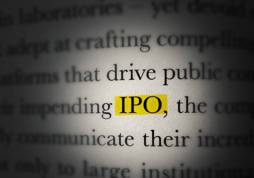 Close up of highlighted IPO text in printed book with blurred surrounding words concept background