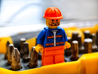 Naklejka premium Russia, St. Petersburg, August 8, 2020 A close-up of a Lego minifigure wearing a construction helmet, perfect for illustrations or designs related to building and construction