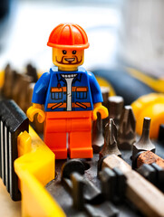 Naklejka premium Russia, St. Petersburg, August 8, 2020 A lego man standing in front of a collection of construction tools, perfect for illustrations, designs and more