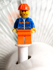 Naklejka premium Russia, St. Petersburg, August 8, 2020 A lego man standing on top of a white fan, great for illustration, presentation or design