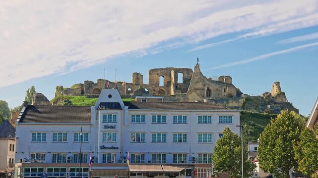 The iconic medieval castle ruins rising above hill and traditional town architecture in Valkenburg, The Netherlands.