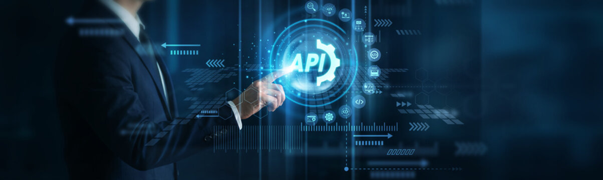 Software developer touching futuristic API interface with glowing digital icons, visualizing application integration, software connectivity, data exchange and digital services for business.