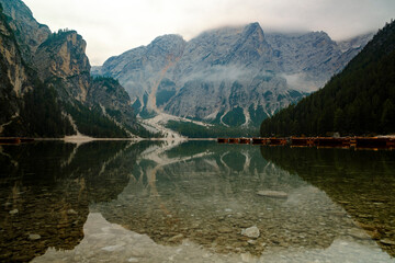 Wooden rowing boats on misty alpine lake in the Dolomites © Will
