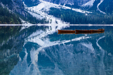 Wooden rowing boats on still alpine lake at dawn © Will