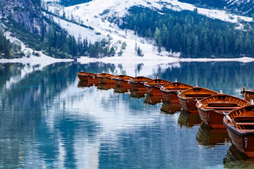 Wooden rowing boats moored on alpine lake in the Dolomites © Will
