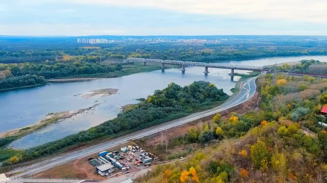 Ufa, Russia. Railway bridge across the Belaya River. The train follows the bridge. Drone footage