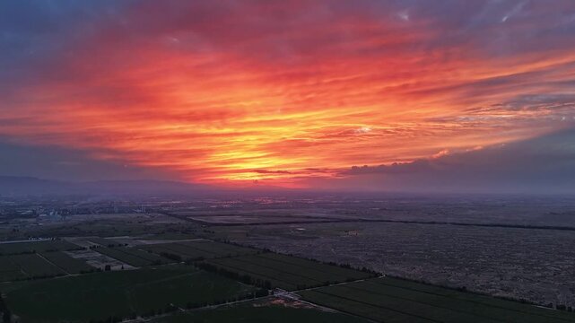 Brilliant sunset clouds over vast farmland fields